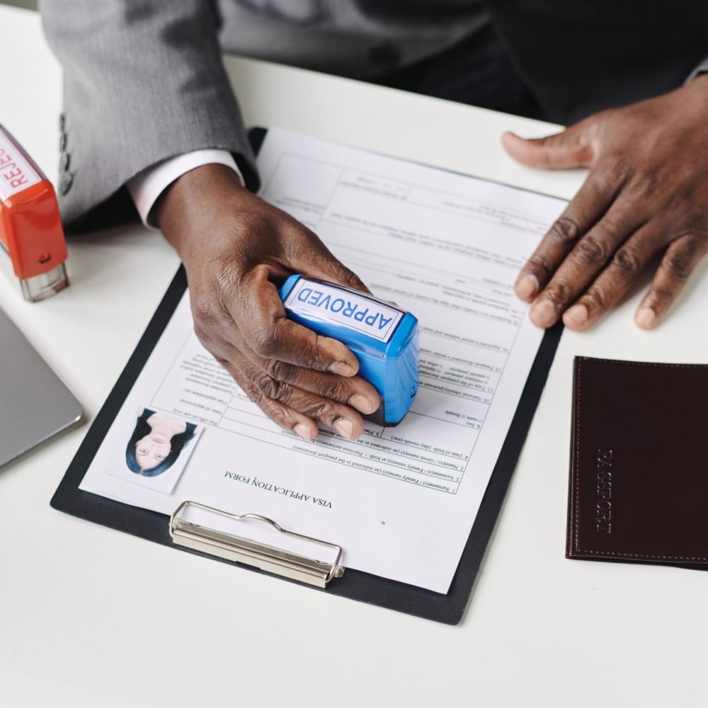 High angle view of African American man approving visa in office