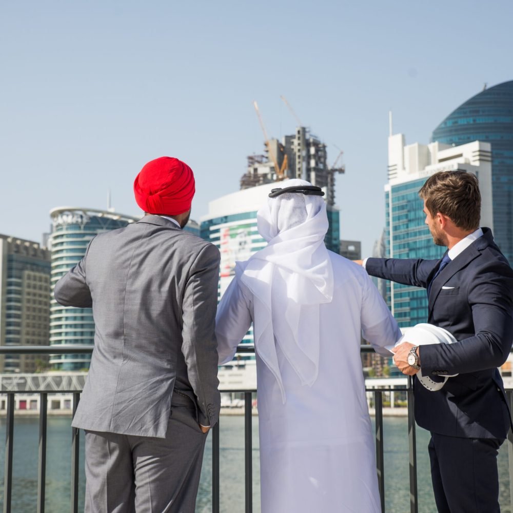 Multiethnic business team meeting outdoors - Three businessmen talking about business on a formal meeting