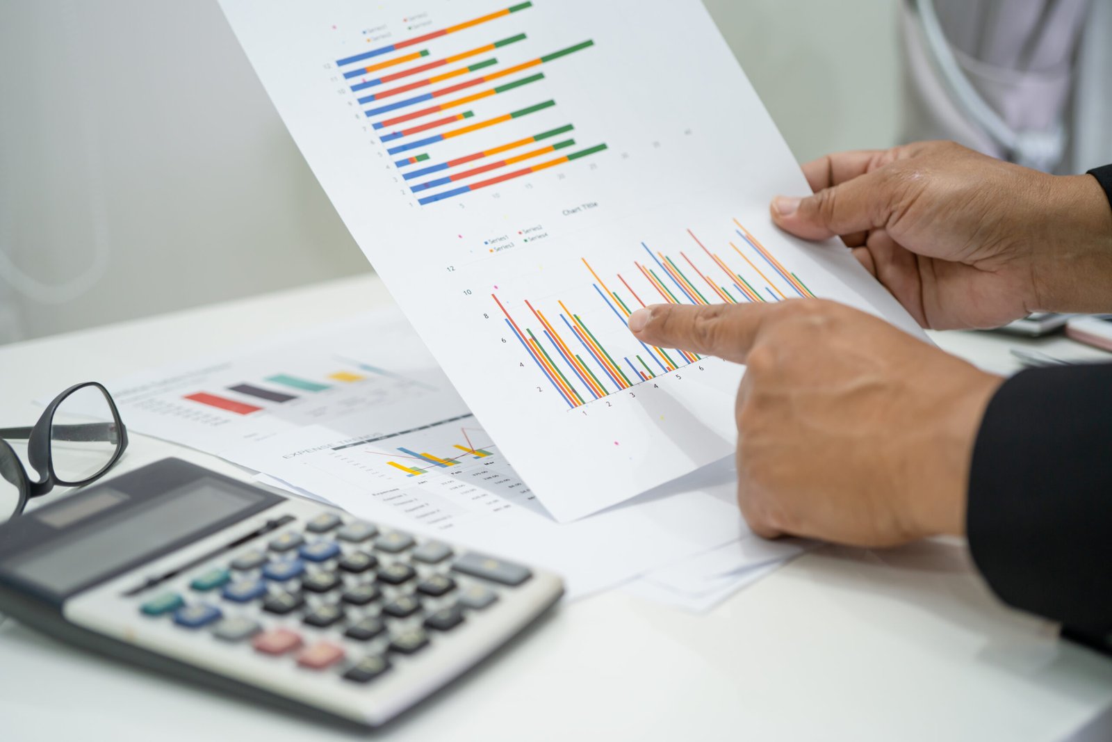 Asian accountant working and analyzing financial reports project Asian accountant working and analyzing financial reports project accounting with chart graph and calculator in modern office, finance and business concept.