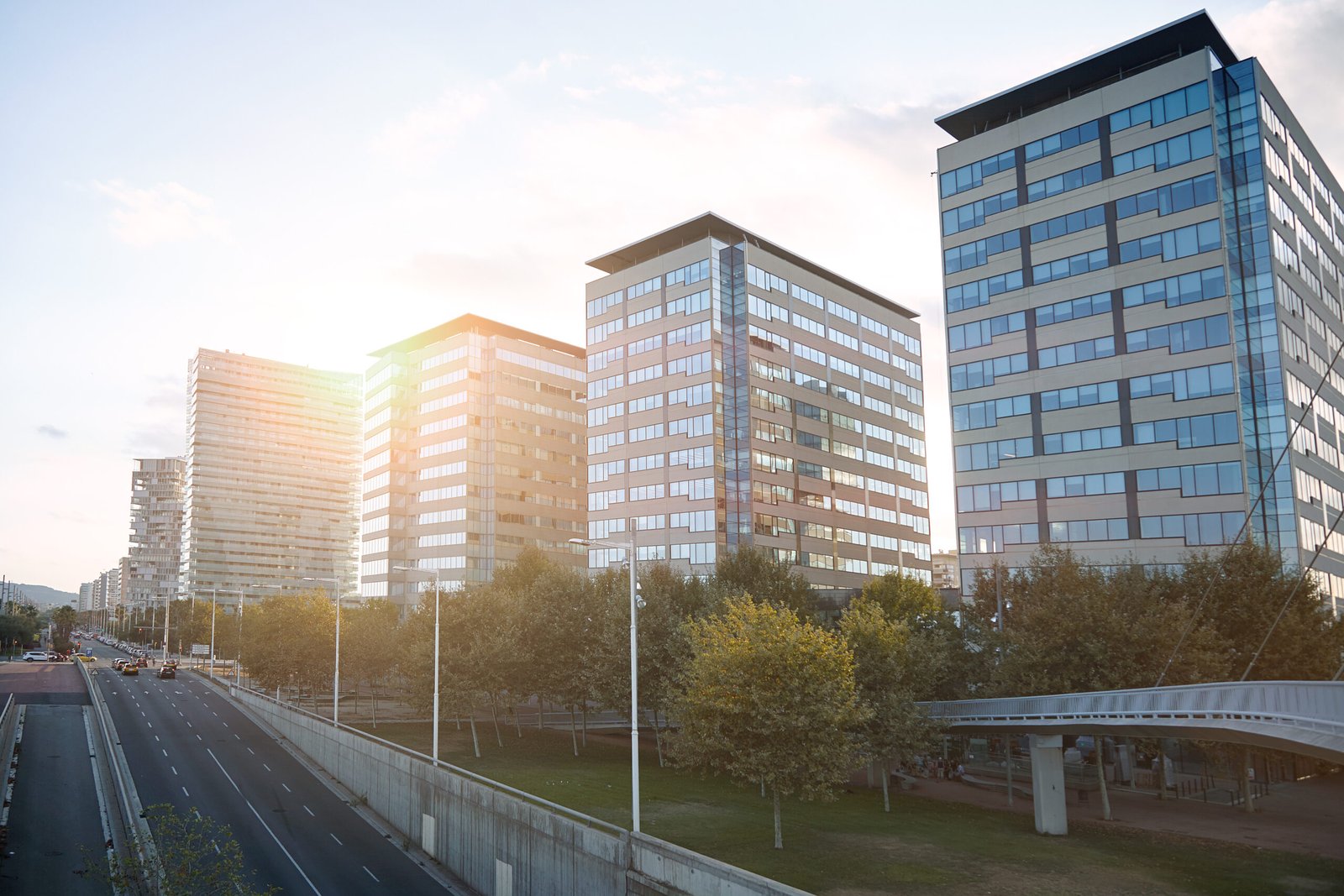 City buildings at sunset High rise city buildings along a highway shot at sunset.
