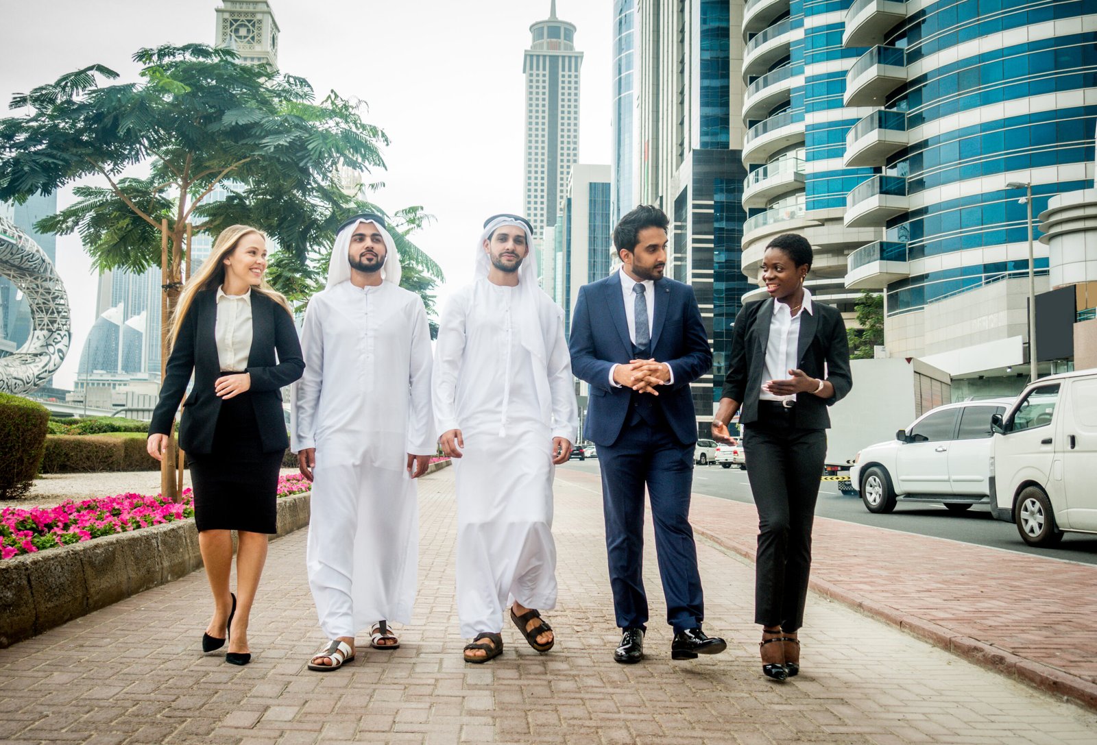 Group of businessmen in Dubai Multi-ethnic group of people on a business meeting in the UAE - Business people walking outdoors and talking about business