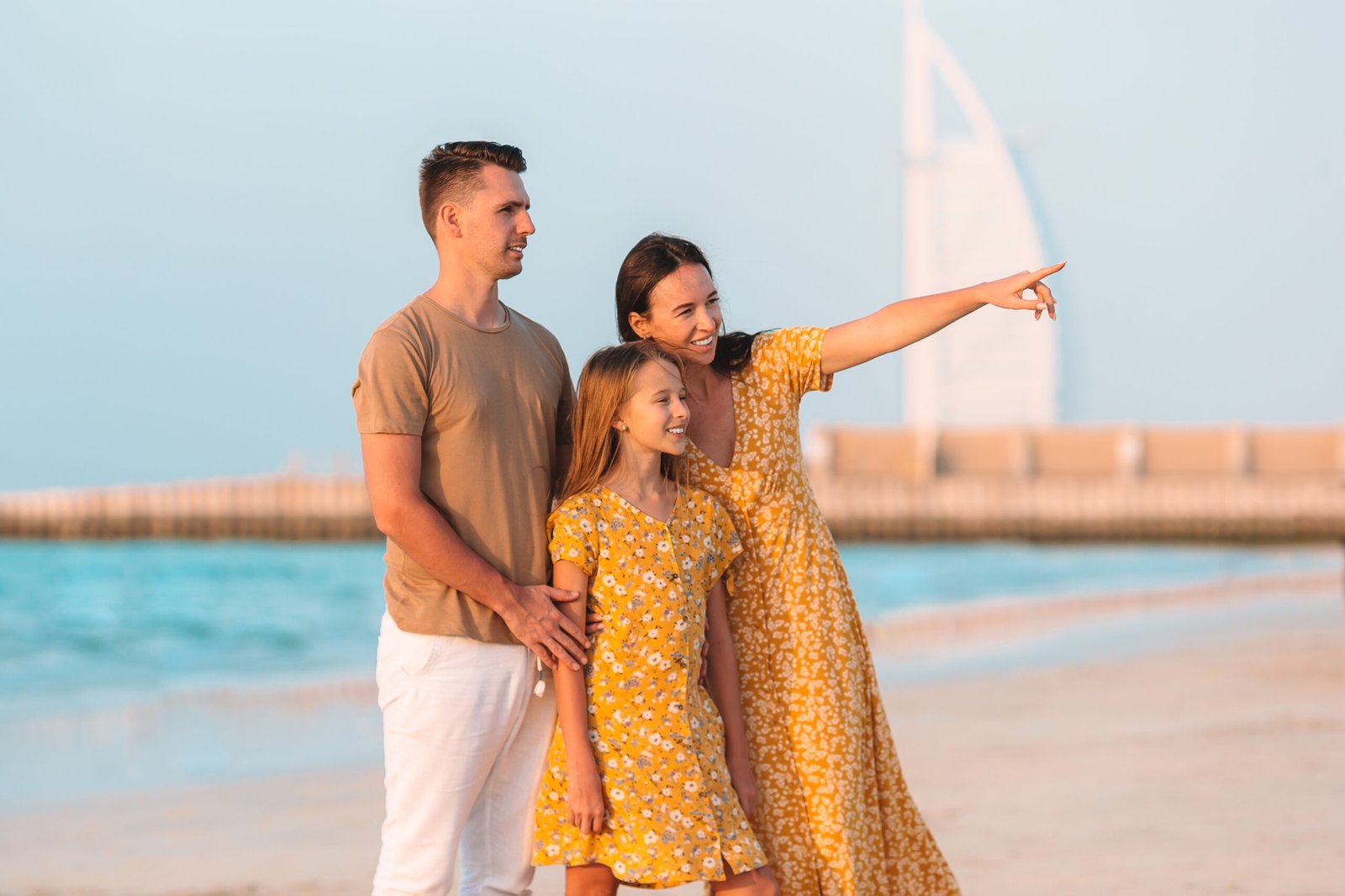 Happy family on the beach during summer vacation Happy family on the beach at summer vacation in Dubai, UAE. United Arab Emirates famous tourist destination.