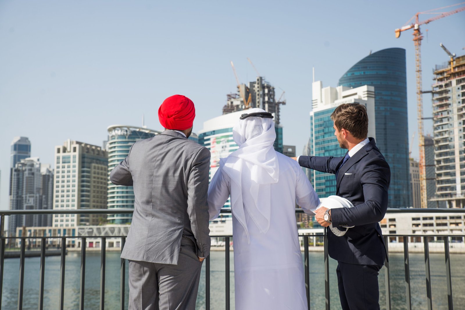 Multi-ethnic business team meeting Multiethnic business team meeting outdoors - Three businessmen talking about business on a formal meeting
